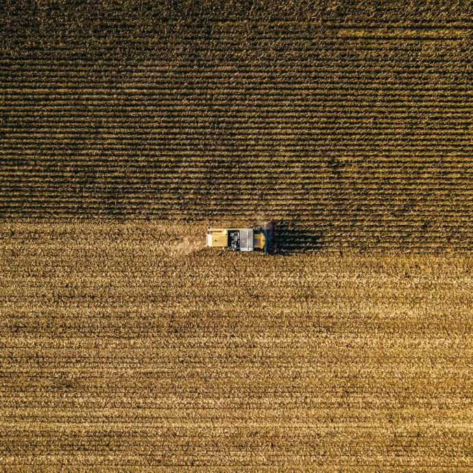 an aerial view of a farm house in a field